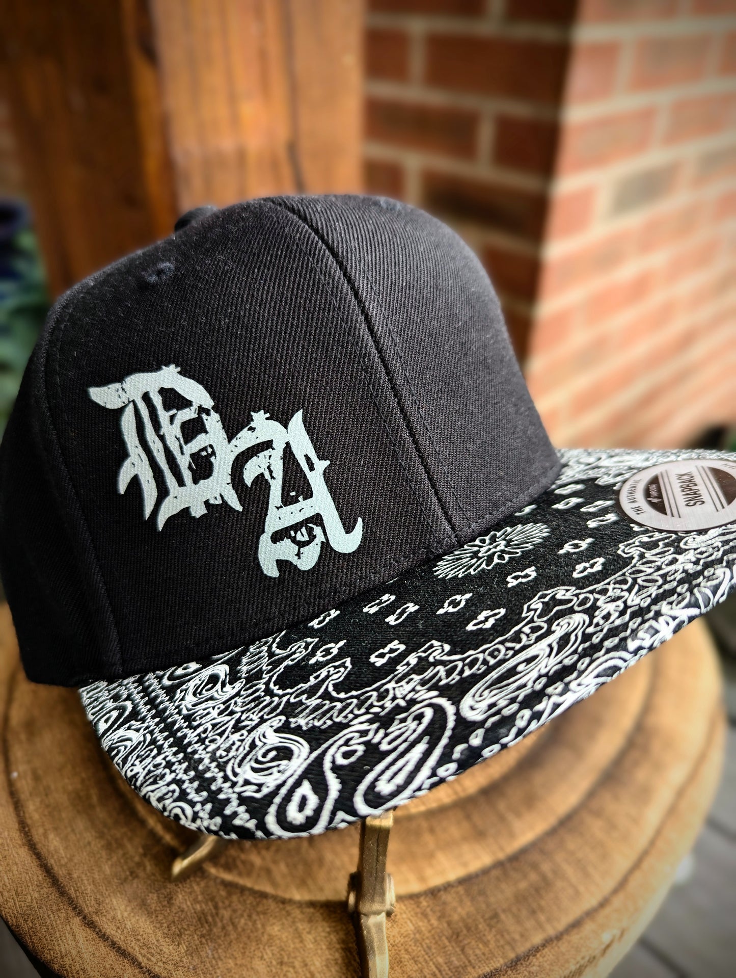 6 panle Snapback hat. Paisley design flat peak. Gothic text logo